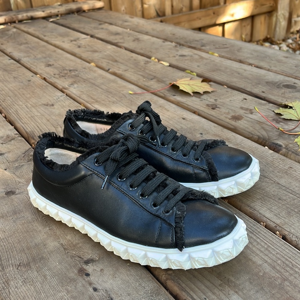 Stuart Weitzman Fringe Cover Story sneakers in black & white